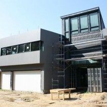 A large house is being built with scaffolding around it
