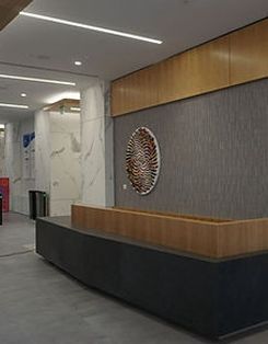 A lobby with a long counter and a painting on the wall