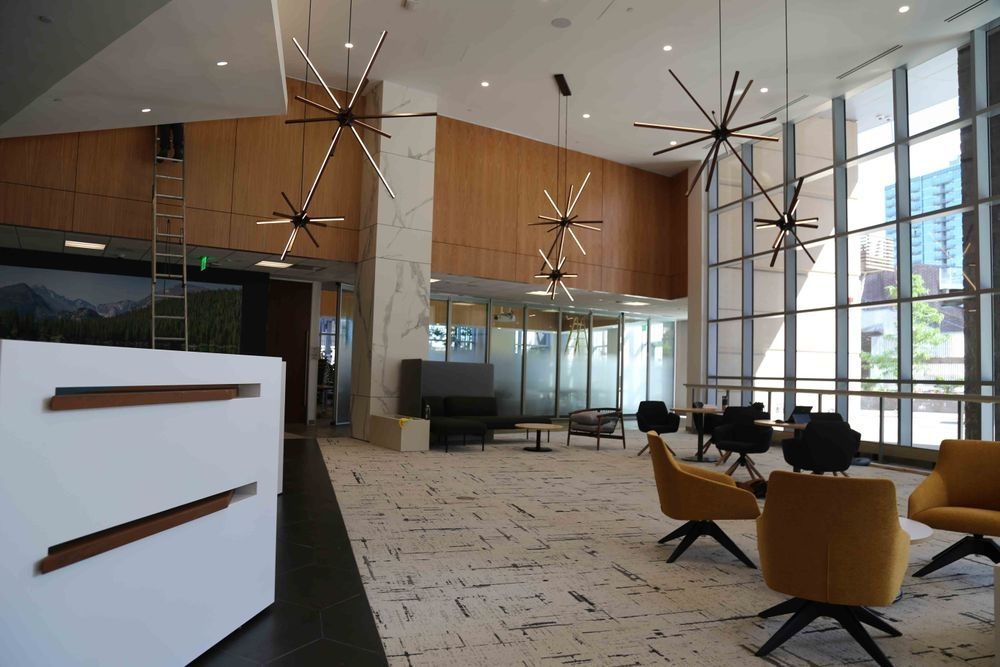 A large lobby with a lot of windows and chairs