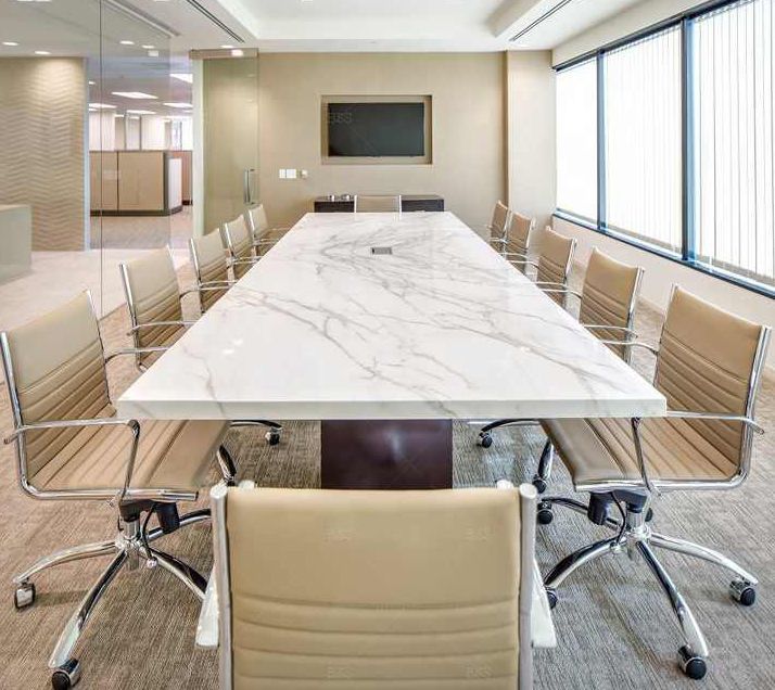 A conference room with a long table and chairs