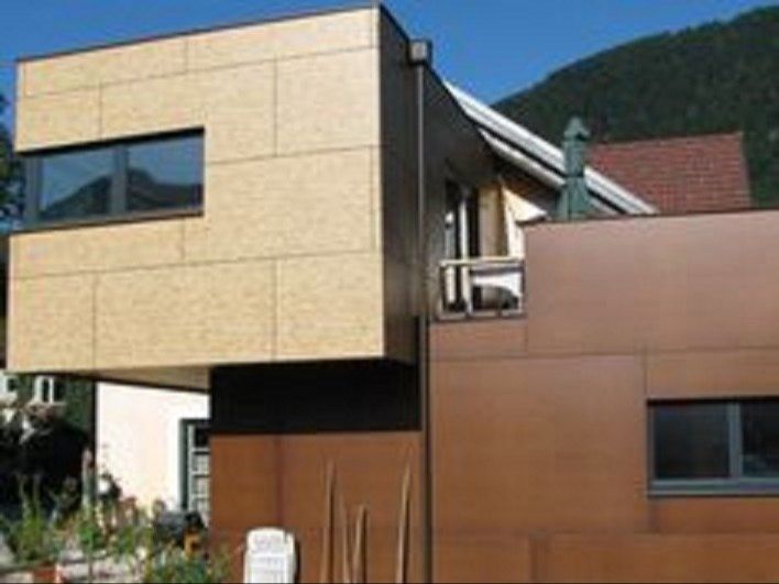A house with a balcony on the top of it