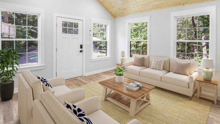 A living room with a couch , chairs , and a coffee table.