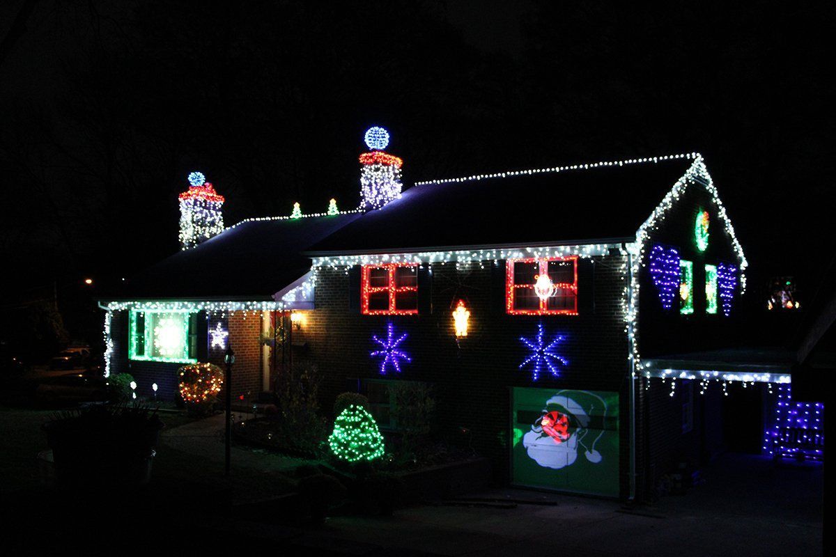 Seattle holiday lighting display - DIY roofline lights with illuminated snowmen figures and colorful LED decorations