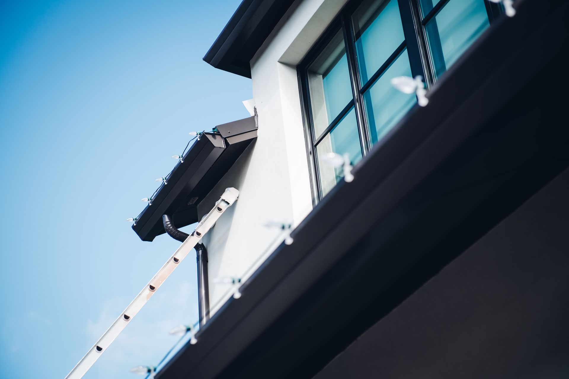 A ladder is hanging from the side of a building.