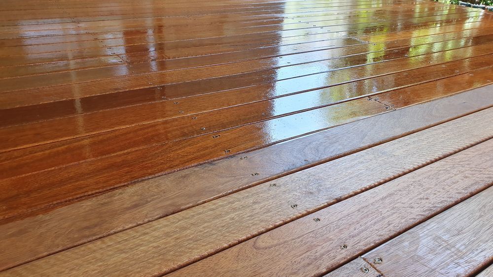 A close up of a wooden deck with a shiny finish.