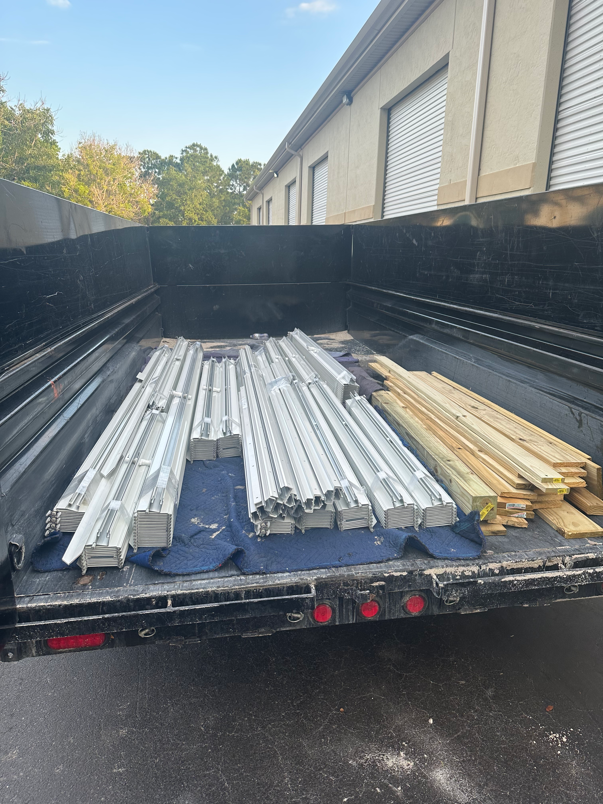 A picture of a pickup truck withh junk on the back