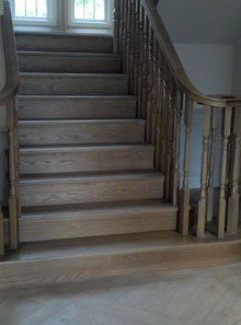 staircase with bannister and railings