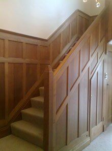 brown staircase with solid bannister