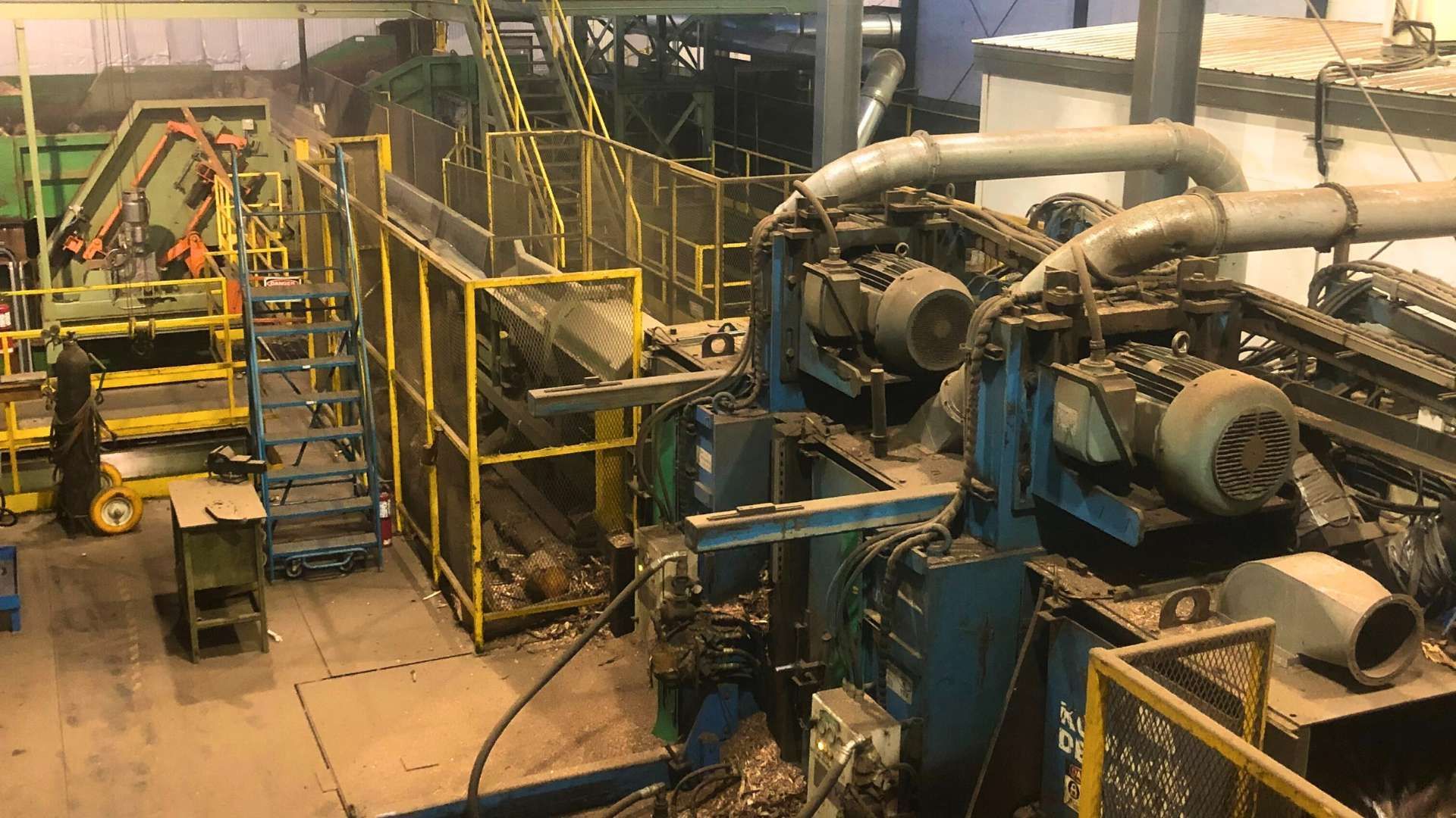 a factory with a lot of machinery and a lot of pipes coming out of it .