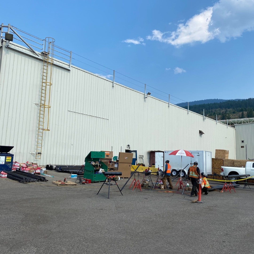 a large white building with a lot of equipment in front of it