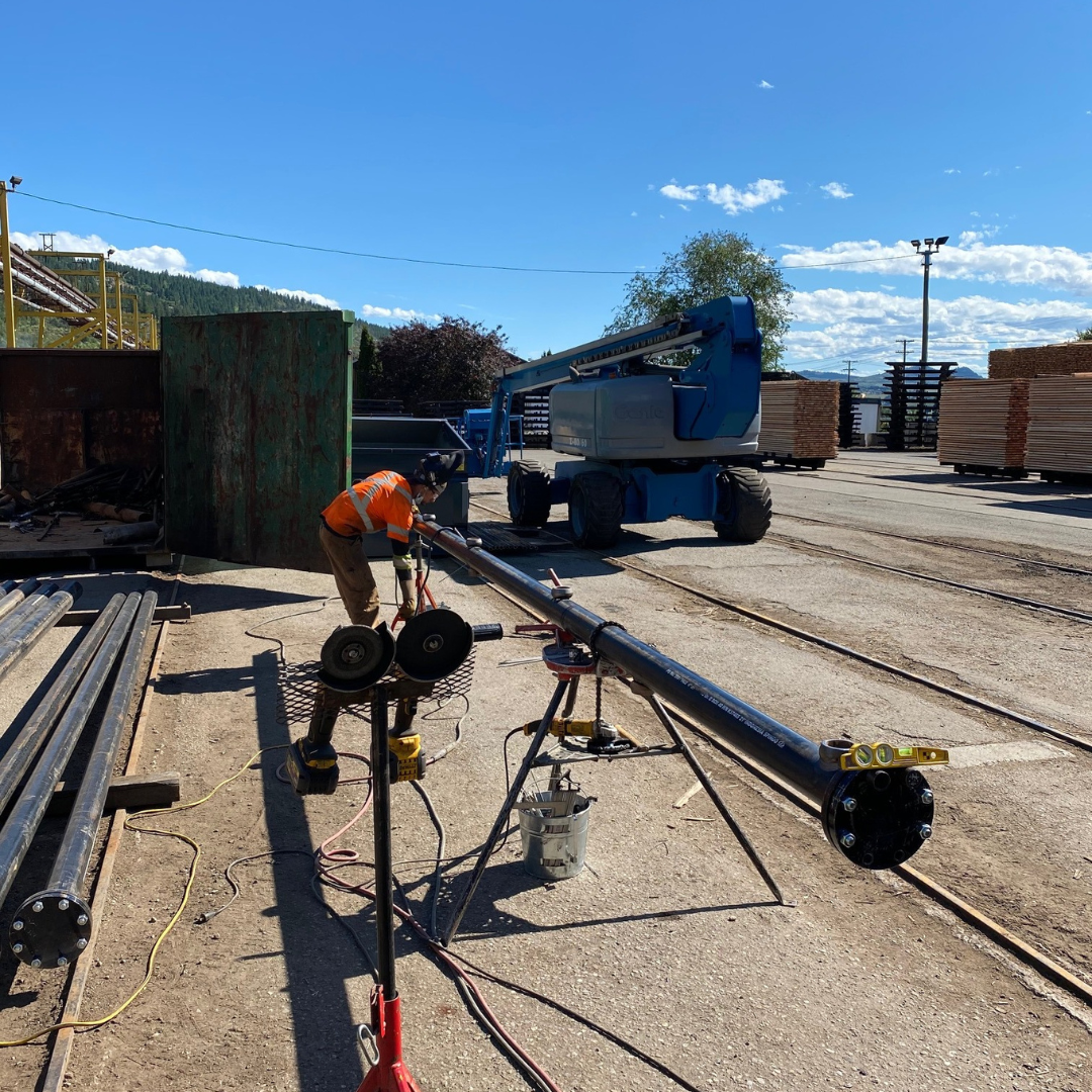 a man in an orange vest is working on a pipe