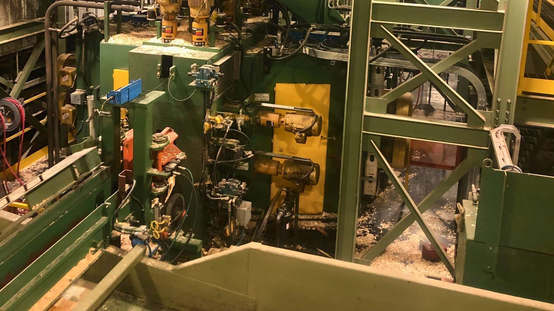 a machine is cutting a piece of wood in a factory .