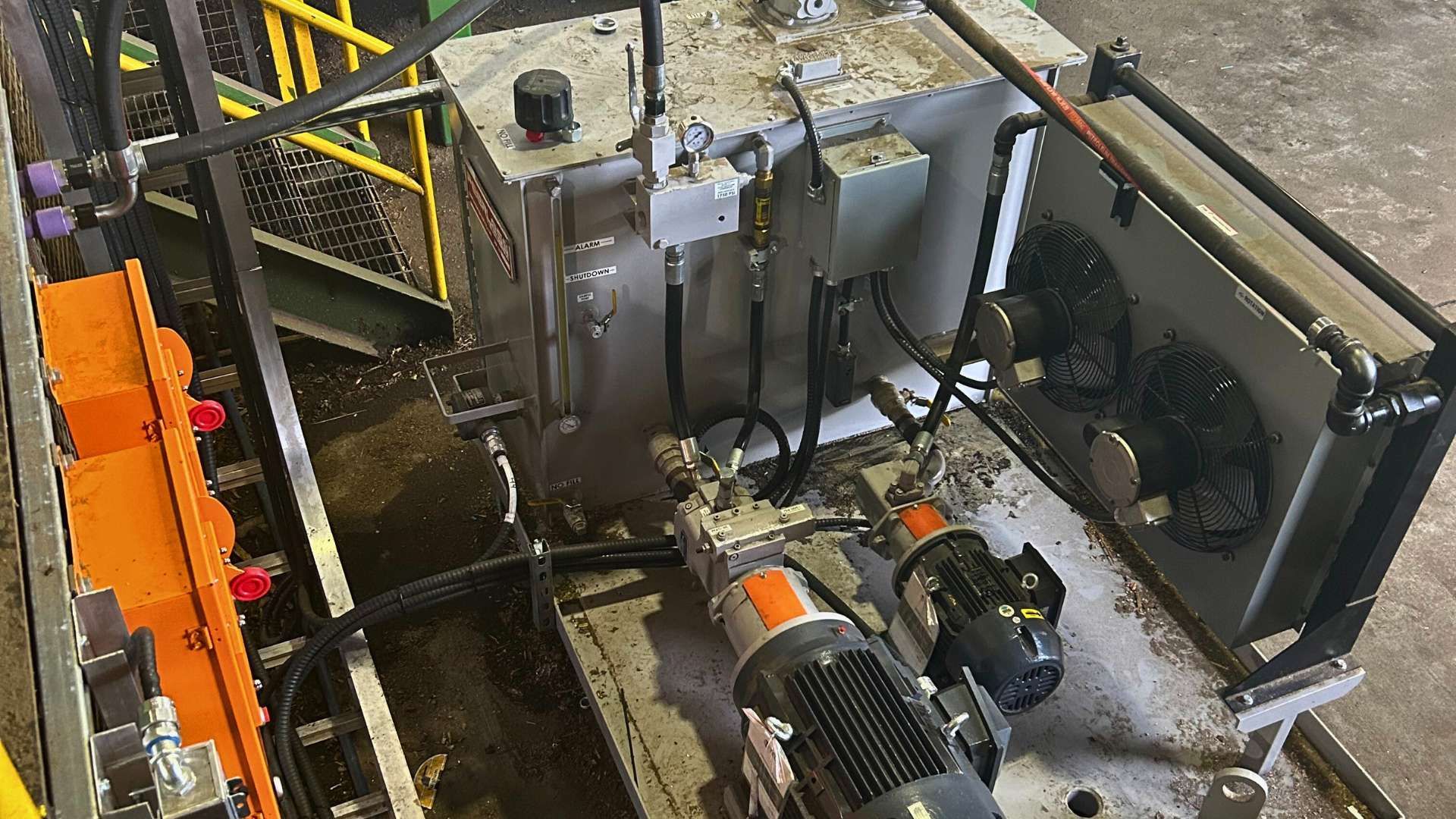 a hydraulic system is sitting on top of a machine in a factory .