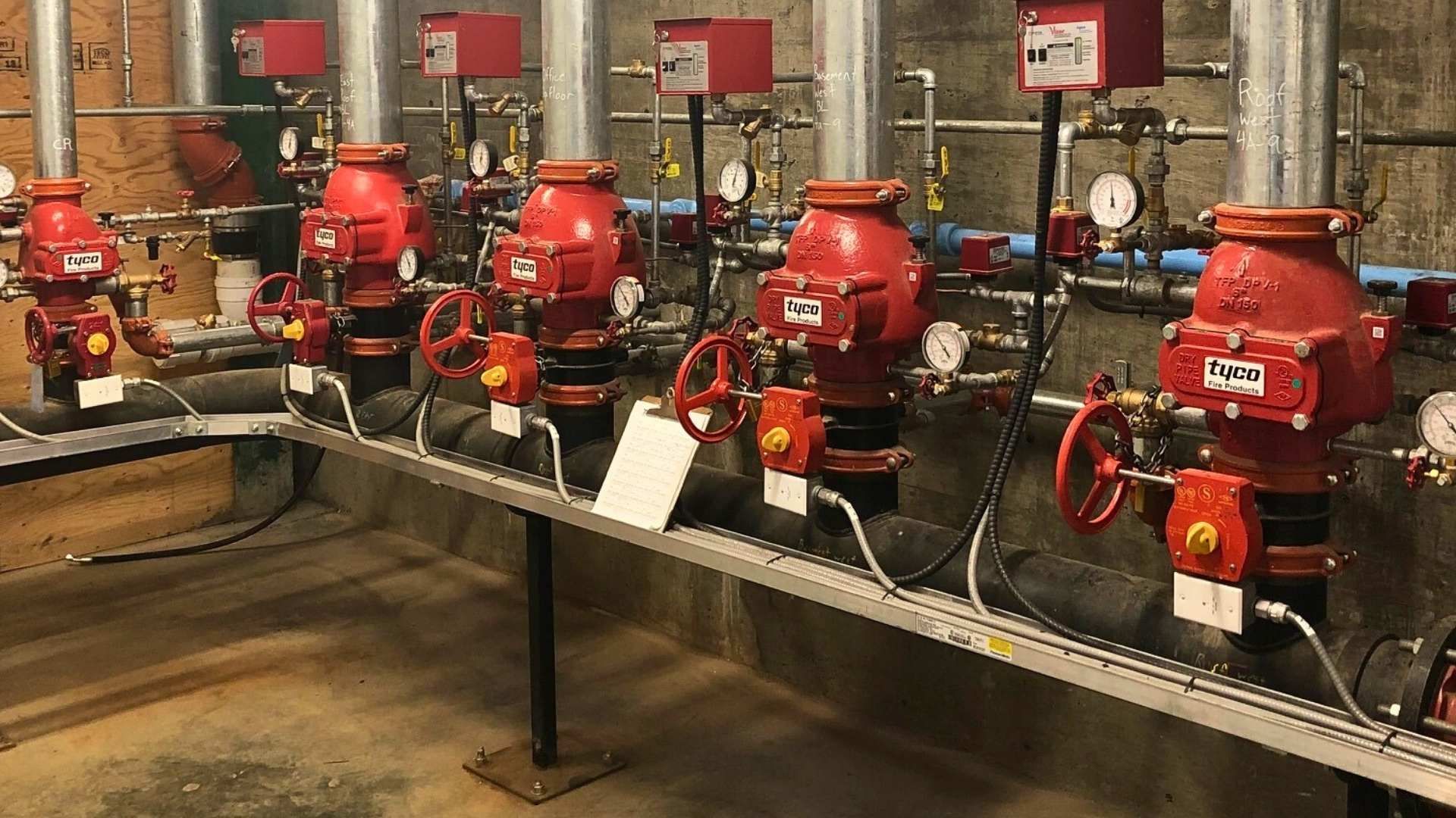 a room filled with lots of red pipes and valves .