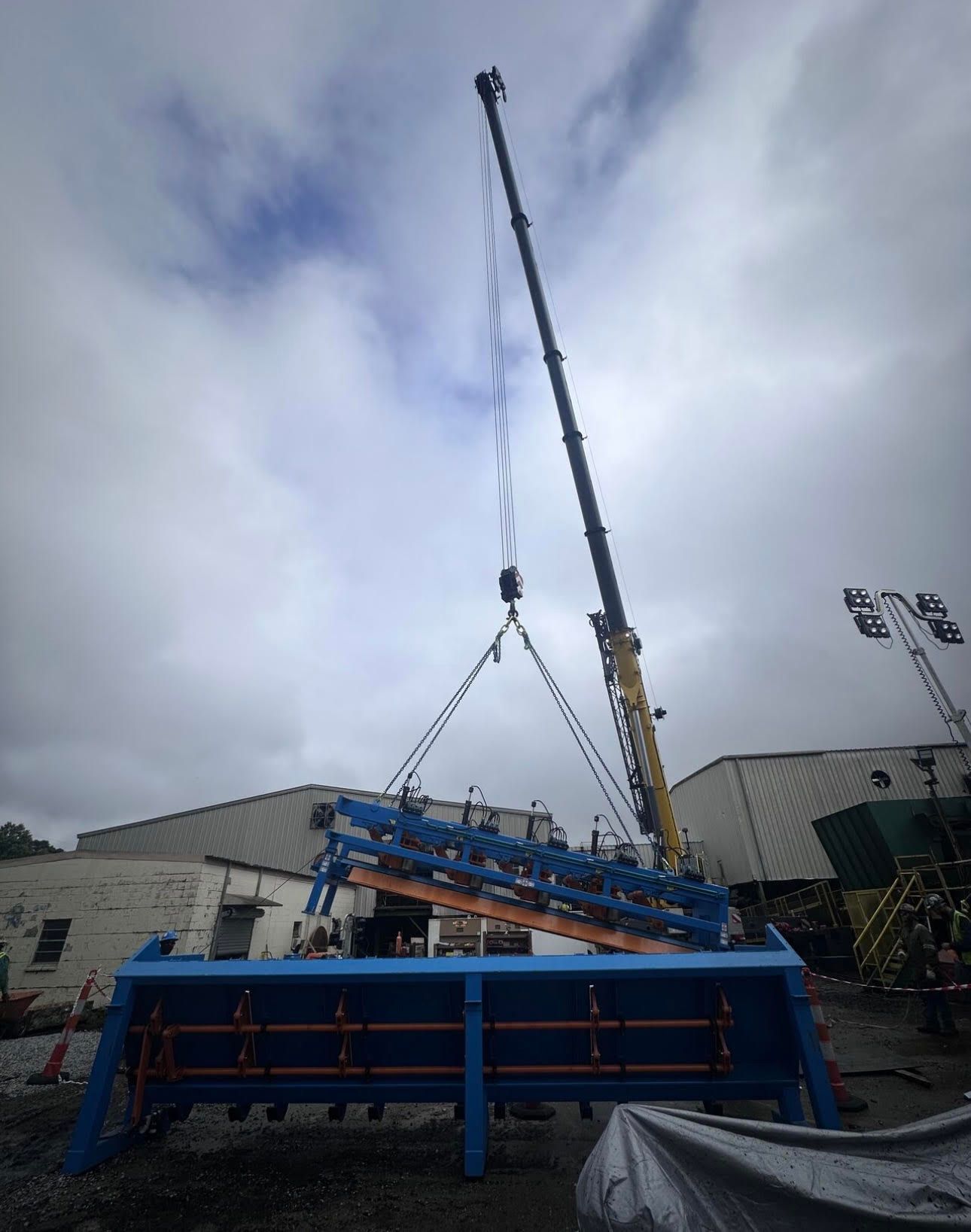 a man is welding a machine in a factory .