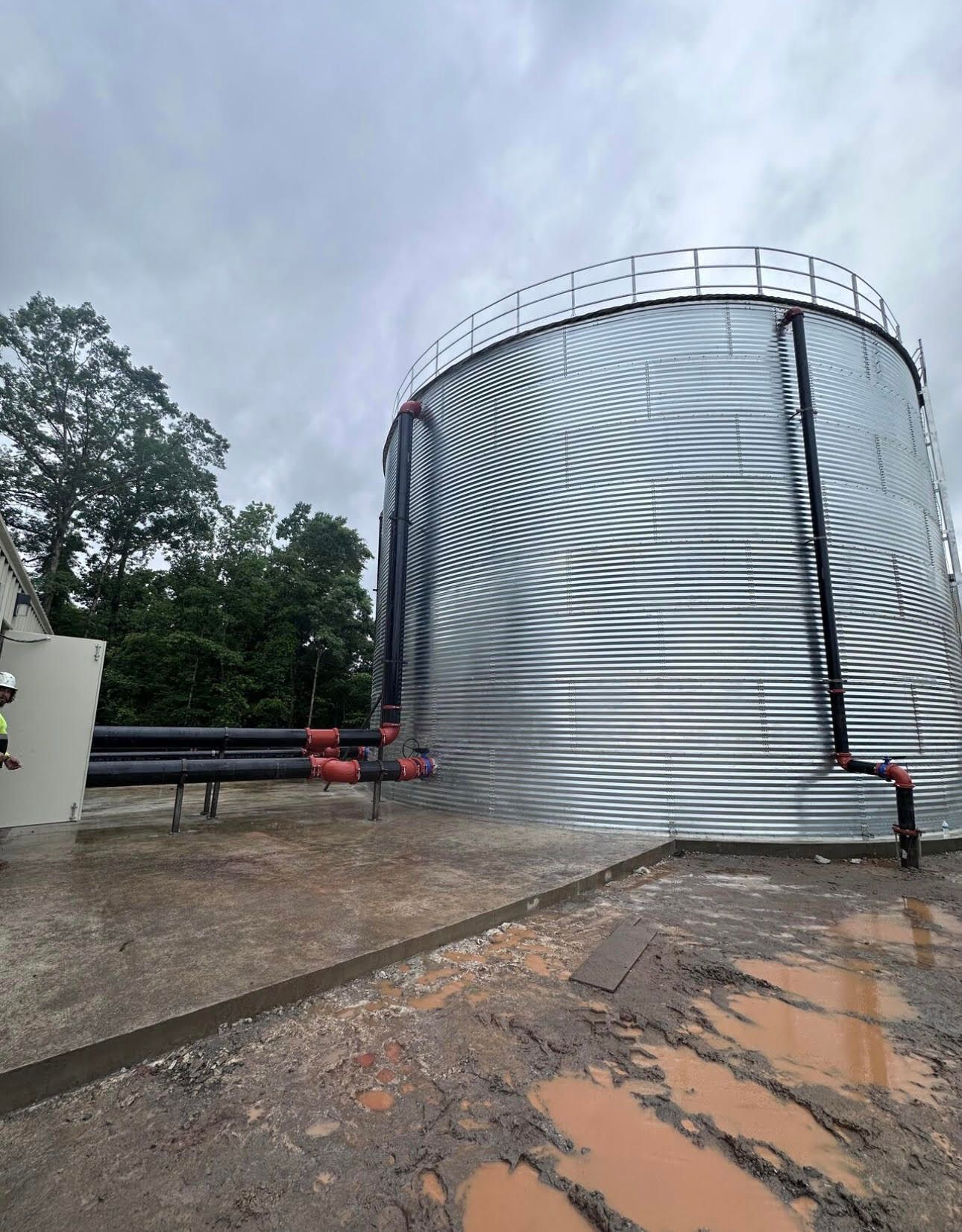 a large green machine is sitting in the middle of a factory .