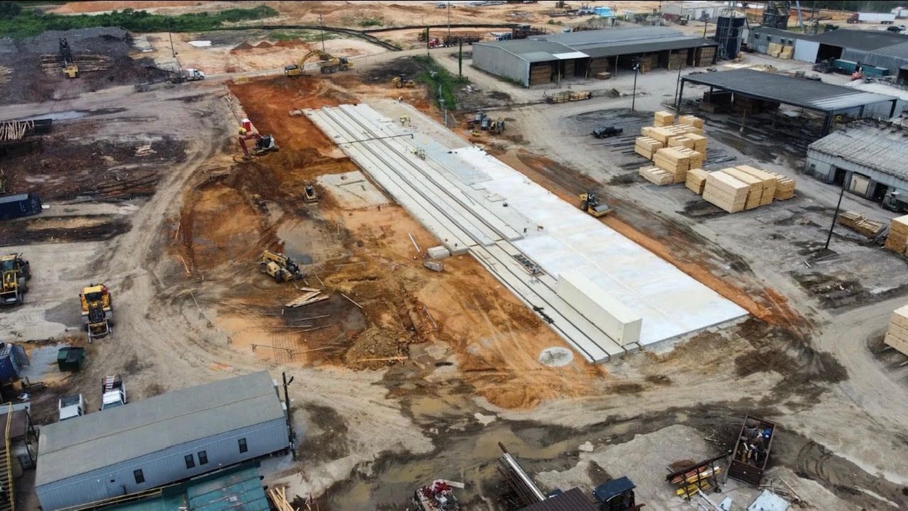 a man is welding a machine in a factory .