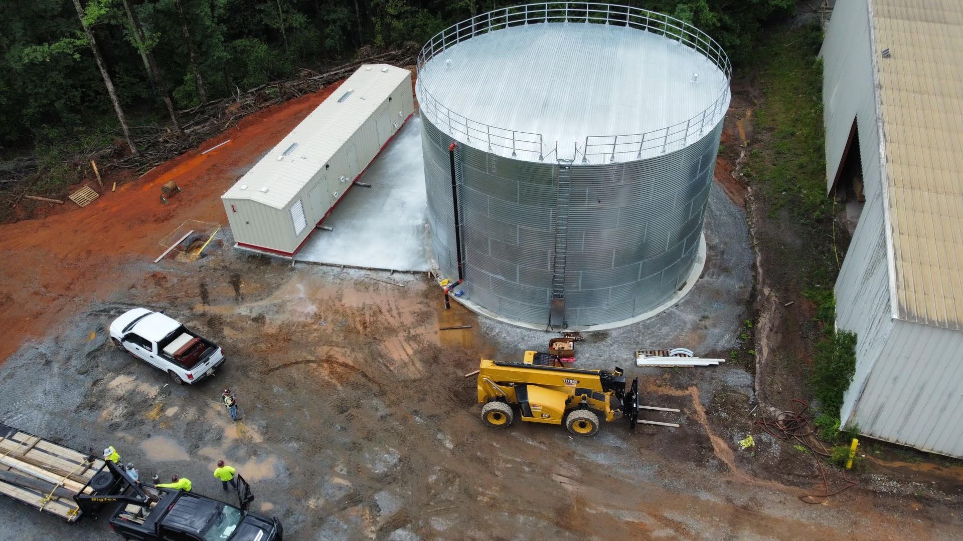 a man is welding a machine in a factory .
