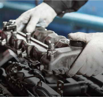 A close up of a person working on a car engine | DAS Auto Werks