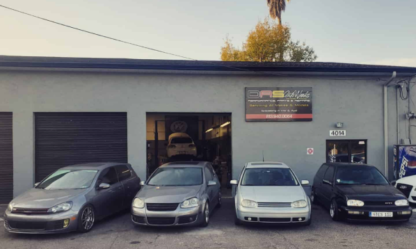 A row of cars are parked in front of a garage | DAS Auto Werks