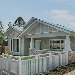 Love Us Or Leave Us - Image: A small house with a white fence in front of it.
