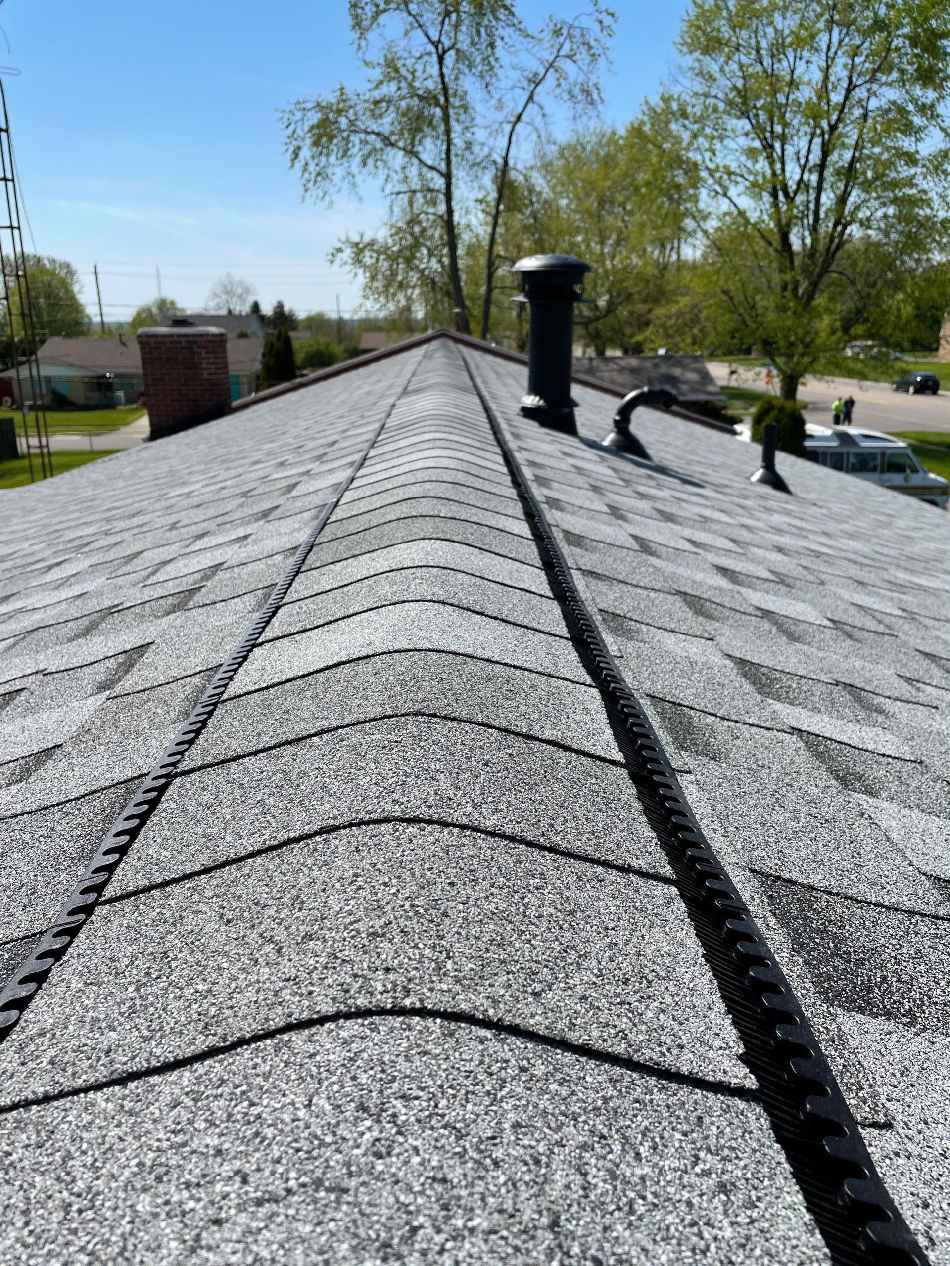 A close up of a roof with a chimney on it.