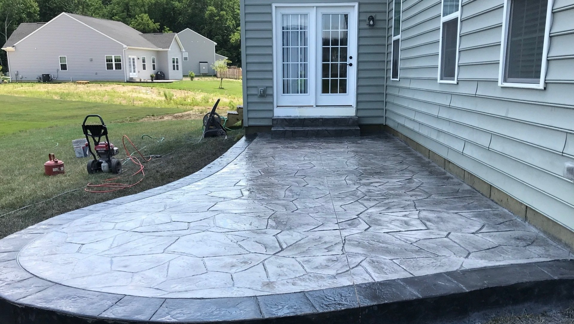 A patio is being built in front of a house.