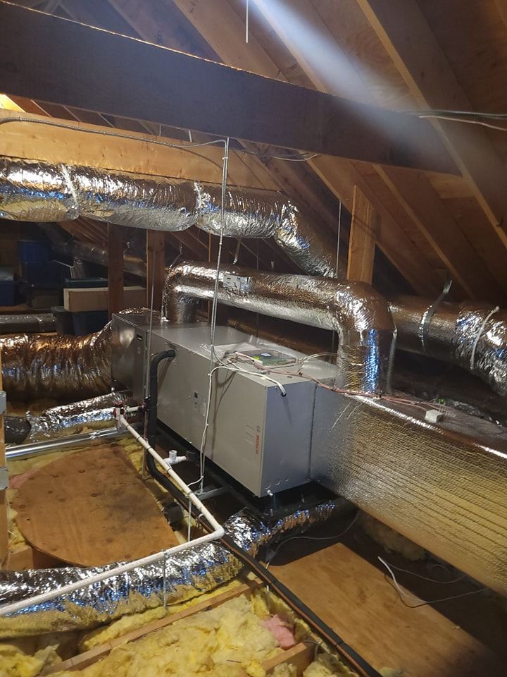 There is a ventilation system in the attic of a house.