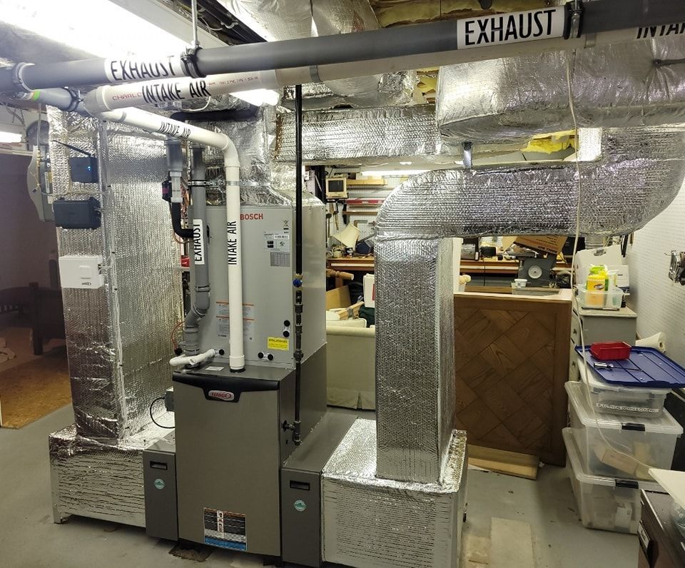 A room with a lot of pipes and a sign that says exhaust