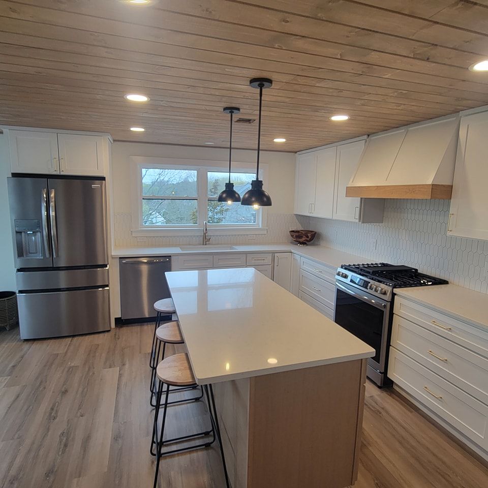A kitchen with stainless steel appliances and white cabinets