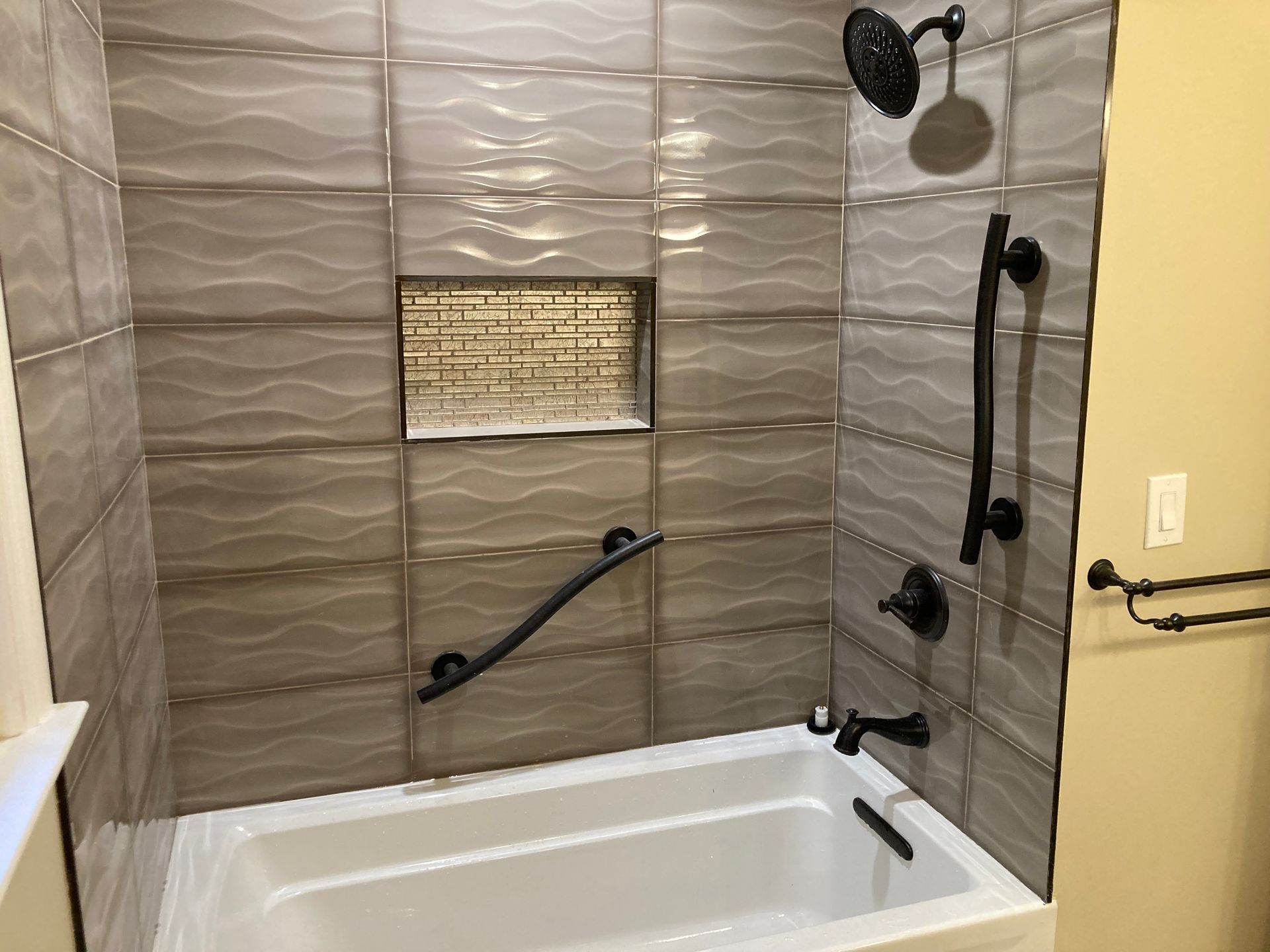 A bathroom with a bathtub and a shower.