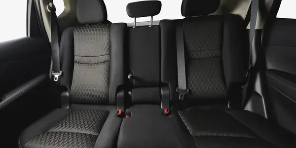 Black car back seats, headrests, and seatbelts.
