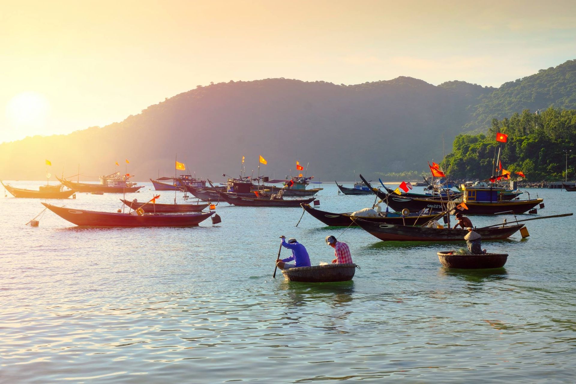 A stunning sunrise over Cu Lao Cham islands, with soft morning light illuminating the horizon.