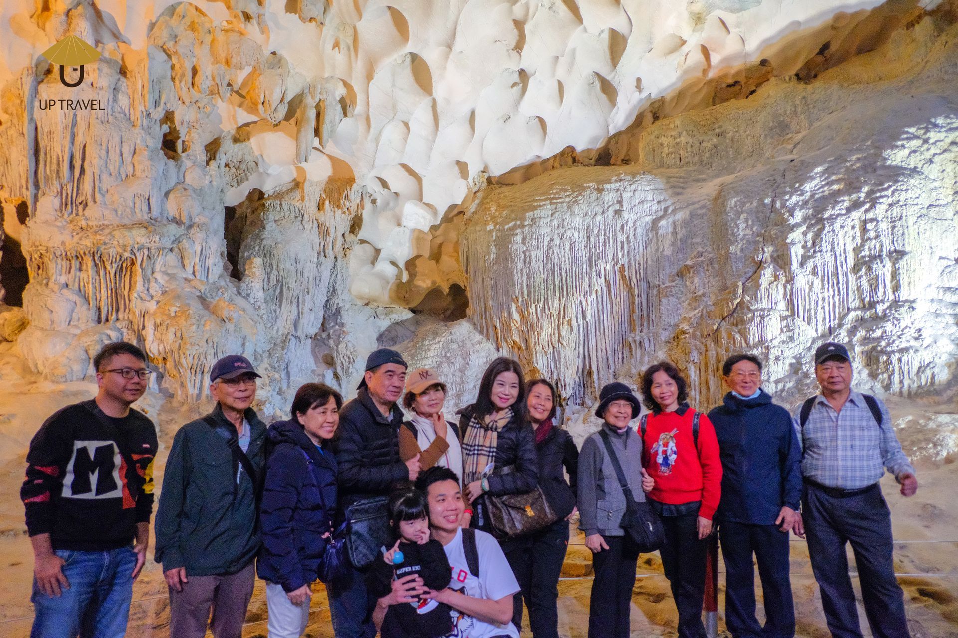 Tour group visiting a limestone cave in northern Vietnam with a local guide.