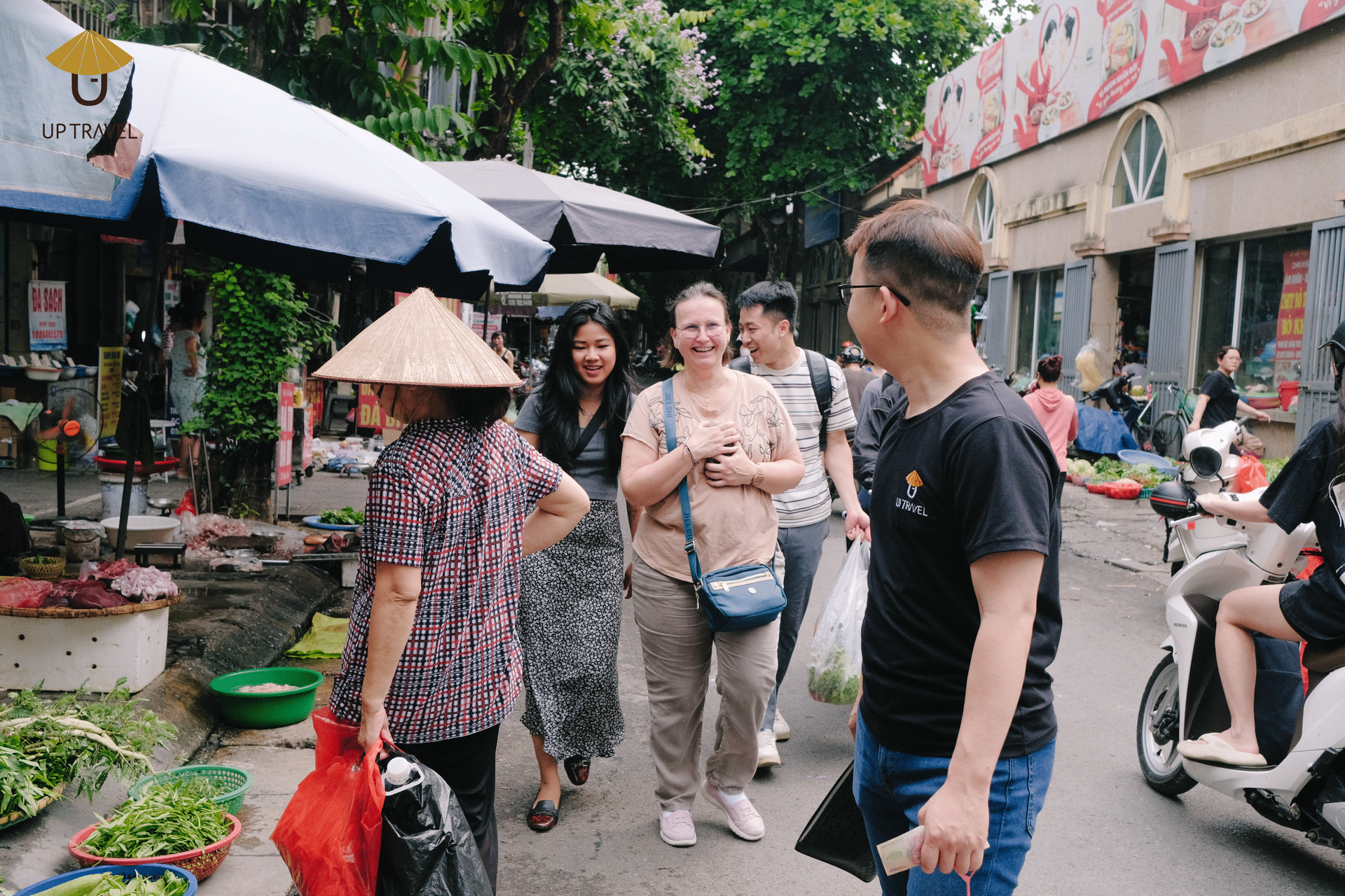 Happy tourists enjoying their visit to a vibrant Vietnamese market.