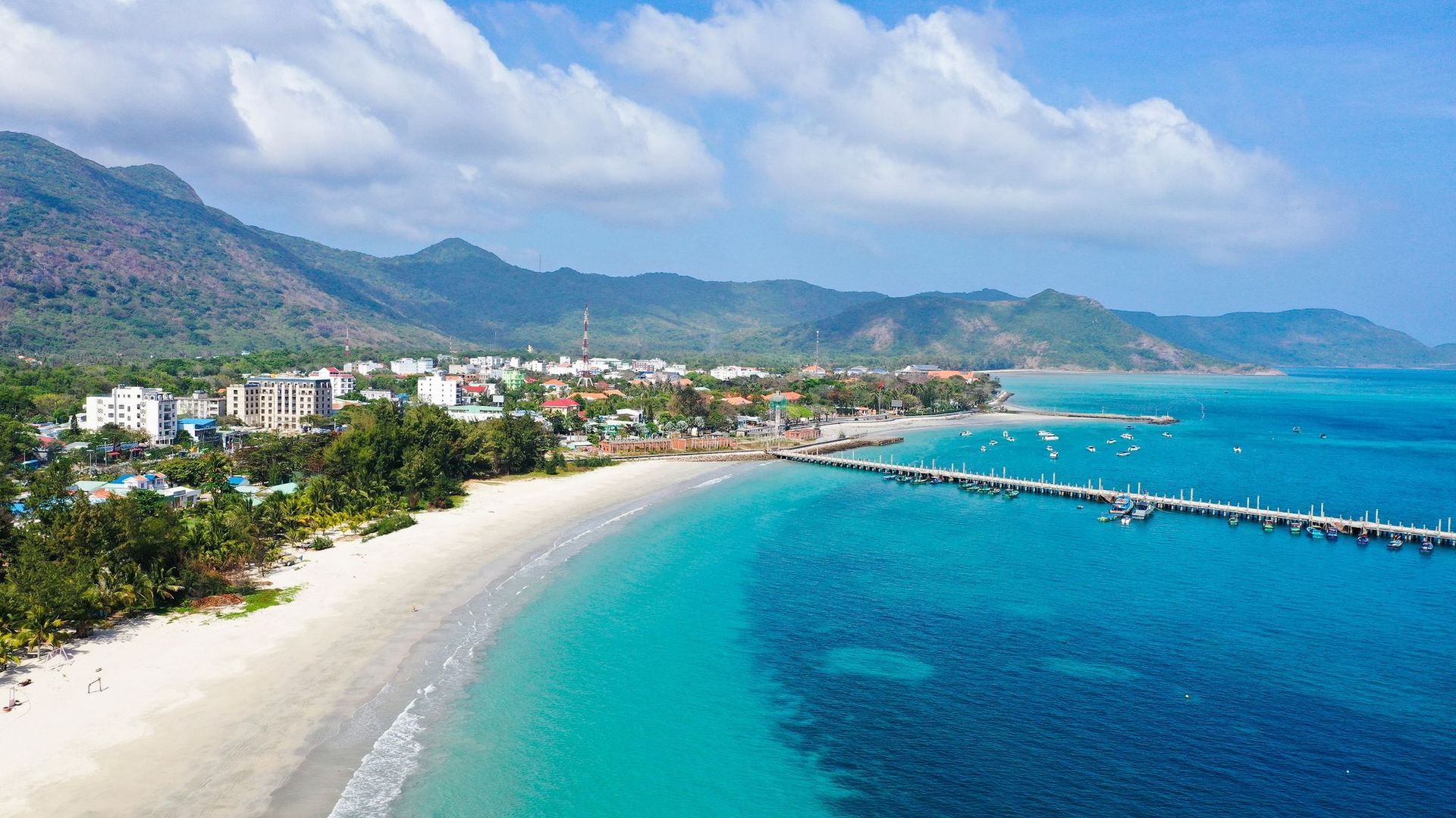 An aerial view of the Con Dao Islands, highlighting their natural beauty and crystal-clear turquoise waters.