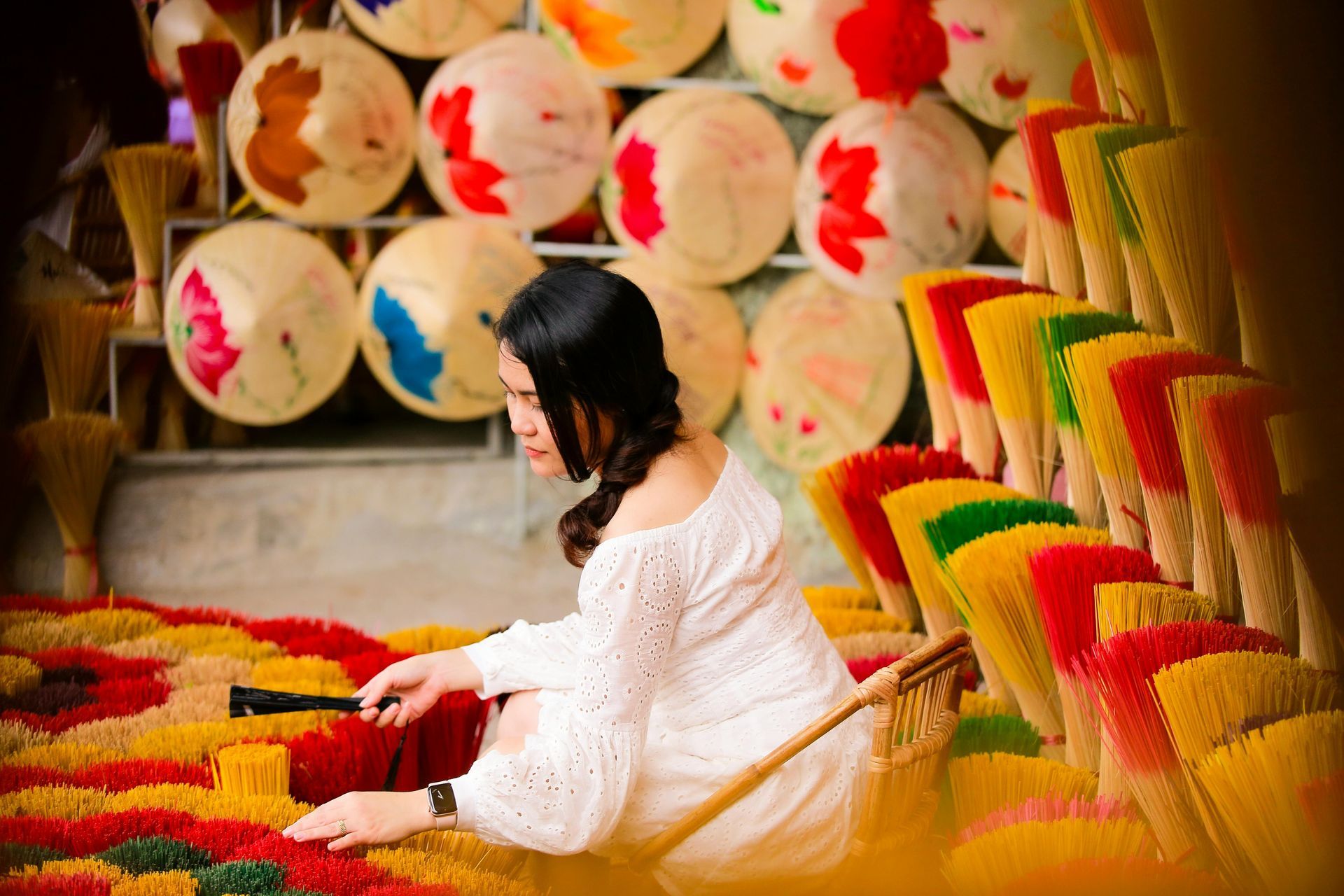 A woman sitting among handcrafted products from Vietnam.