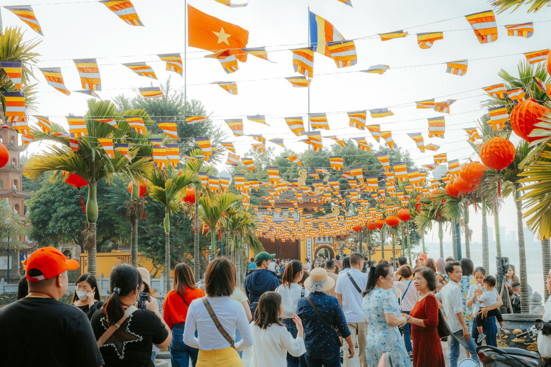 People dressed in festive attire visiting a temple during Tet, reflecting the vibrant and spiritual start to the Lunar New Year.