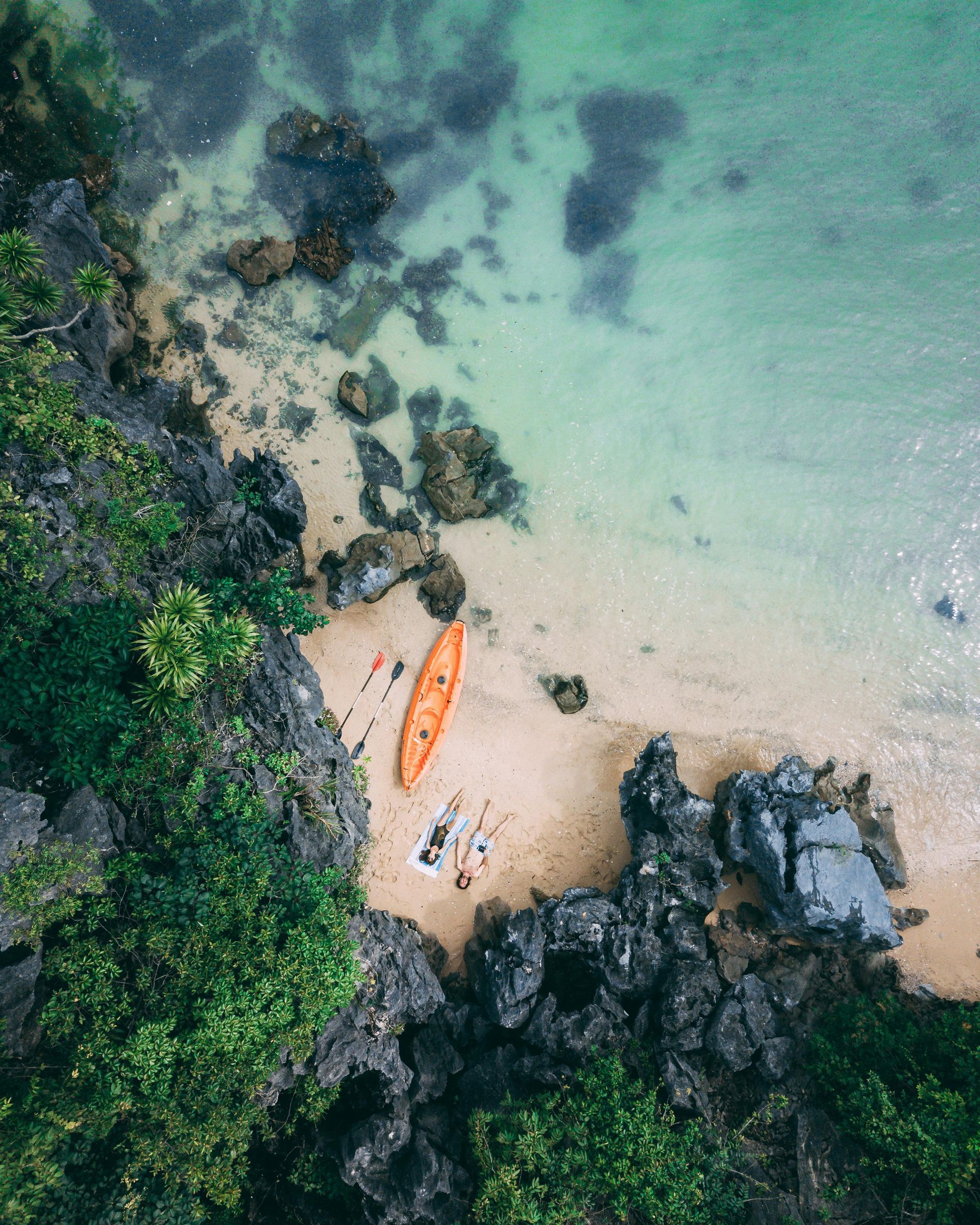 A scenic view of Vietnam's island beaches with clear blue waters and a rugged coastline.