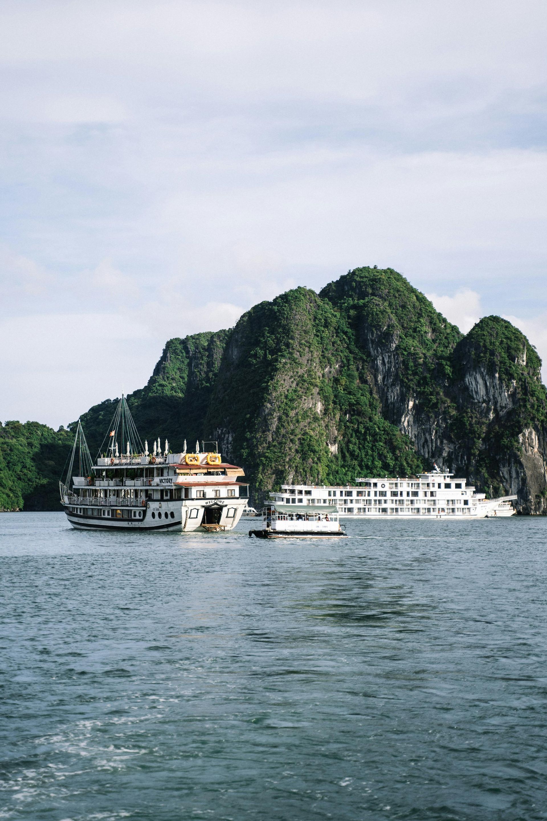 Cruise ships floating among limestone karsts in Ha Long Bay, Vietnam.