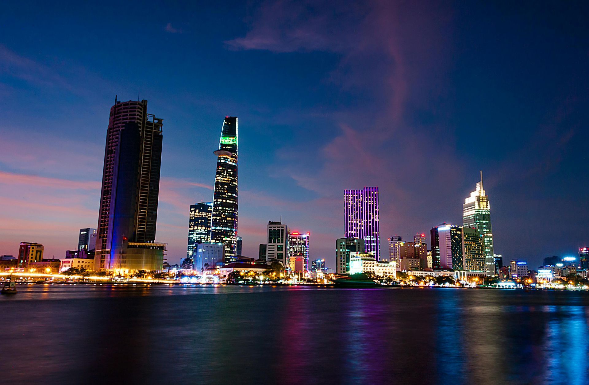 Ho Chi Minh City skyline at night, with bright lights and bustling streets.