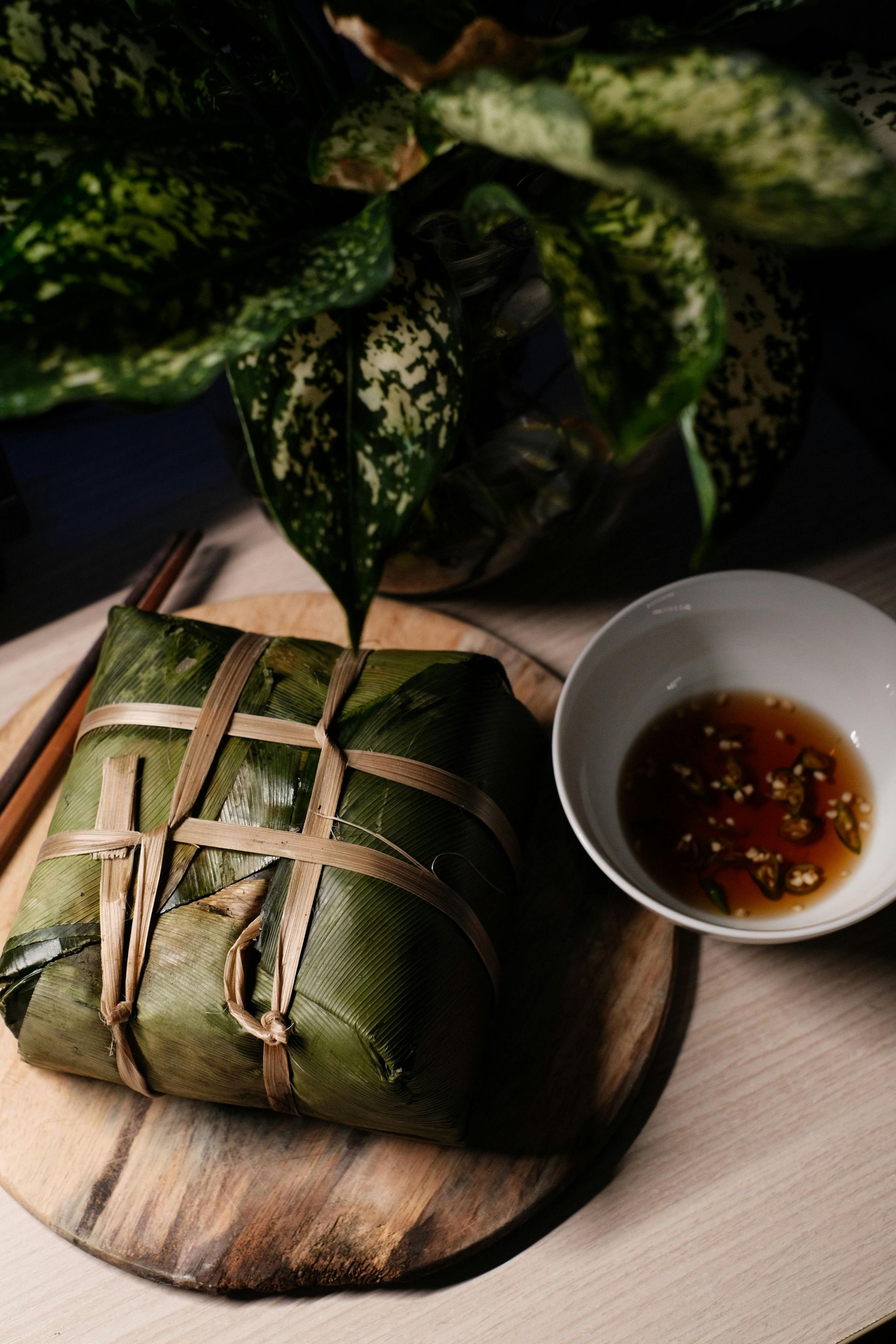 A neatly wrapped square Banh Chung, the traditional Vietnamese rice cake, symbolizing Tet festivities.