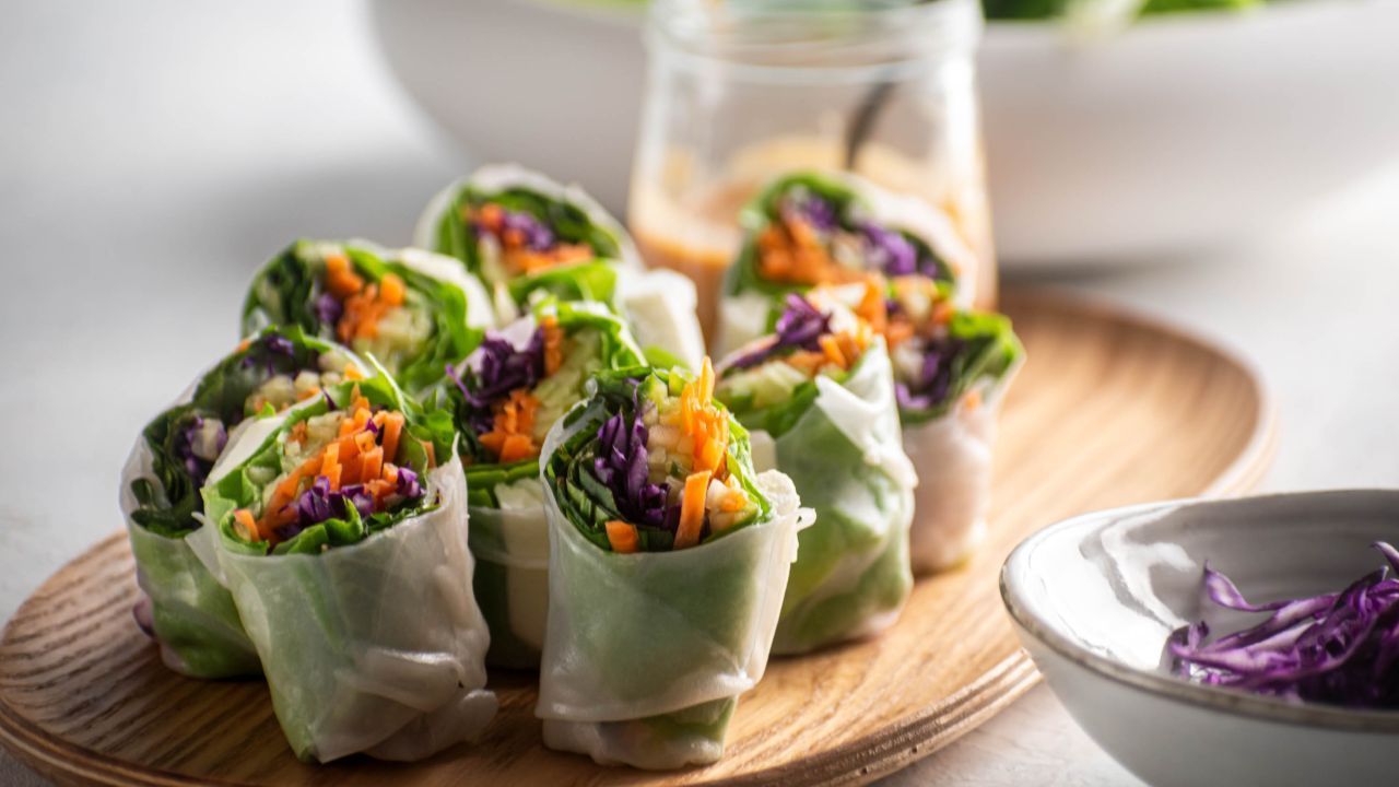 A plate of vibrant gỏi cuốn chay (vegan fresh spring rolls) filled with fresh vegetables and herbs.