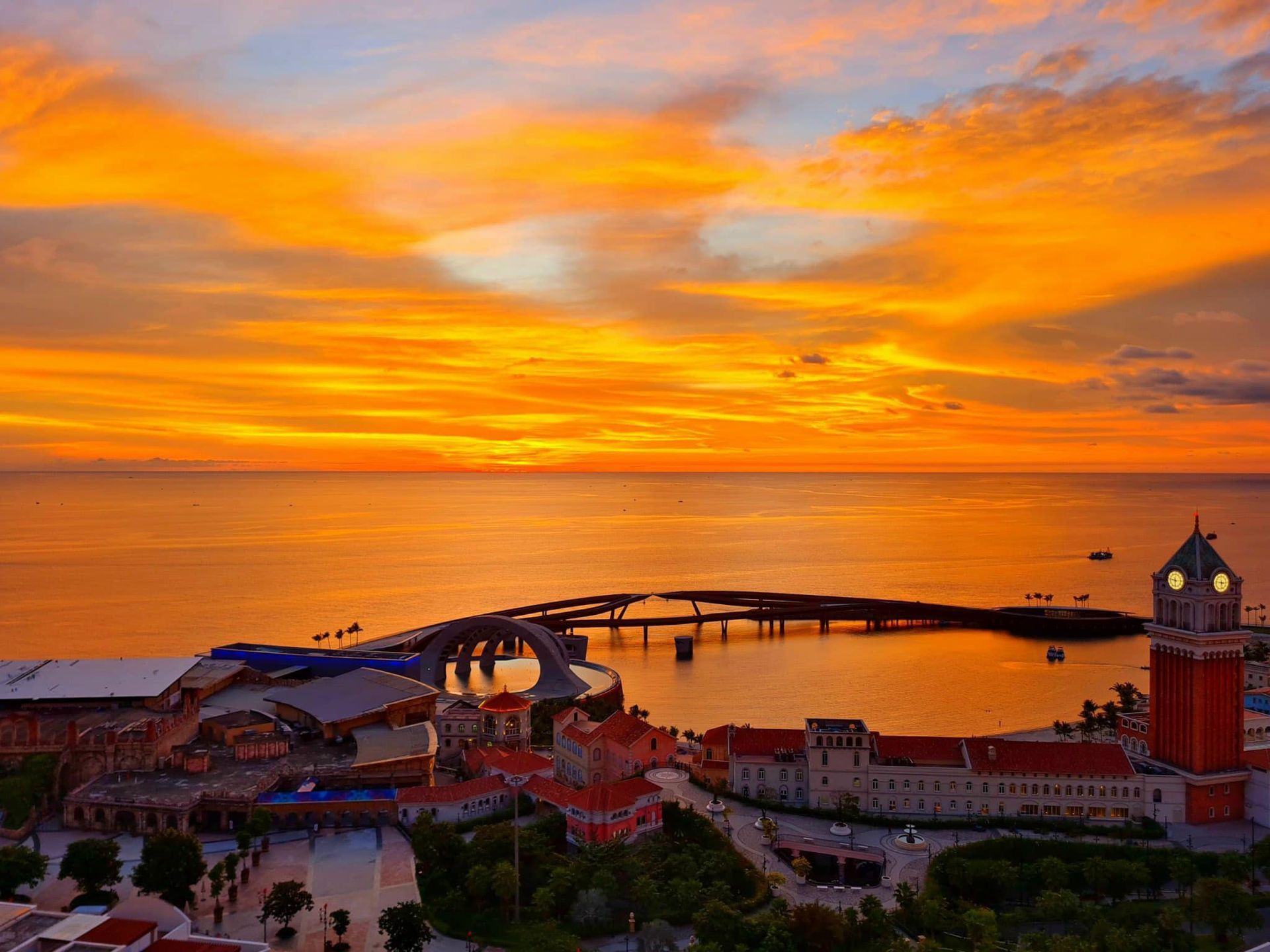 A vibrant sunset over Phu Quoc Island, with colorful skies reflecting on tranquil waters.