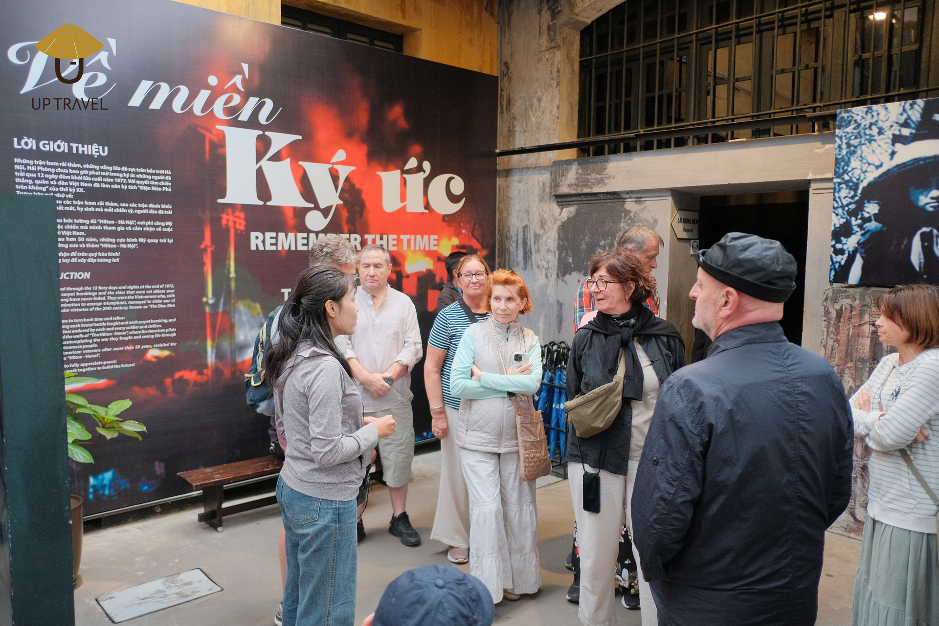 Tourists listening to a guide at Hoa Lo Prison Museum in Hanoi.