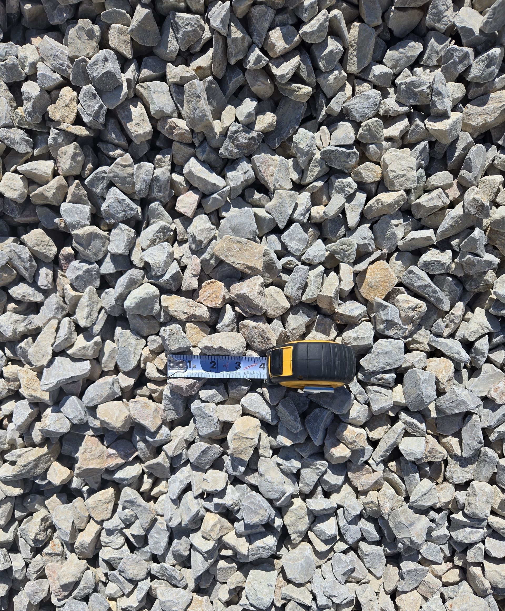 A pile of rocks with a tape measure sitting on top of them.