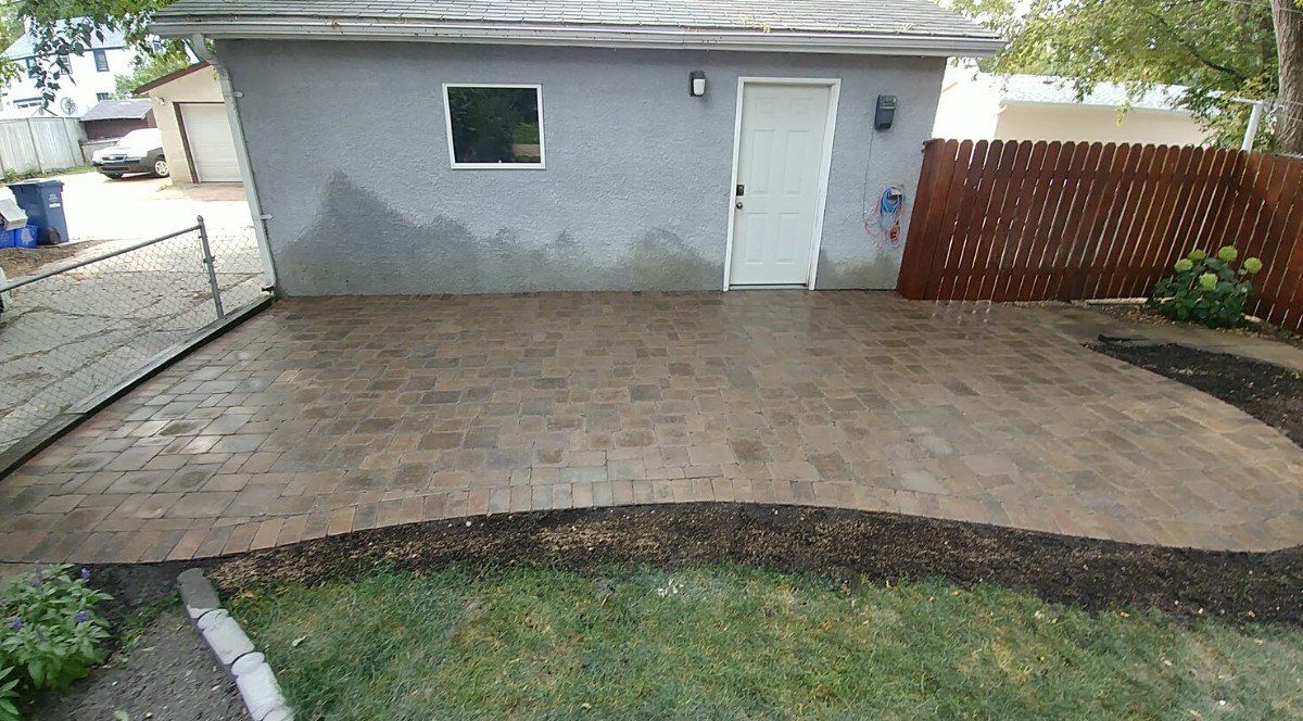 A small house with a patio in front of it.