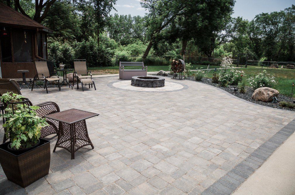 There is a fire pit in the middle of the patio.