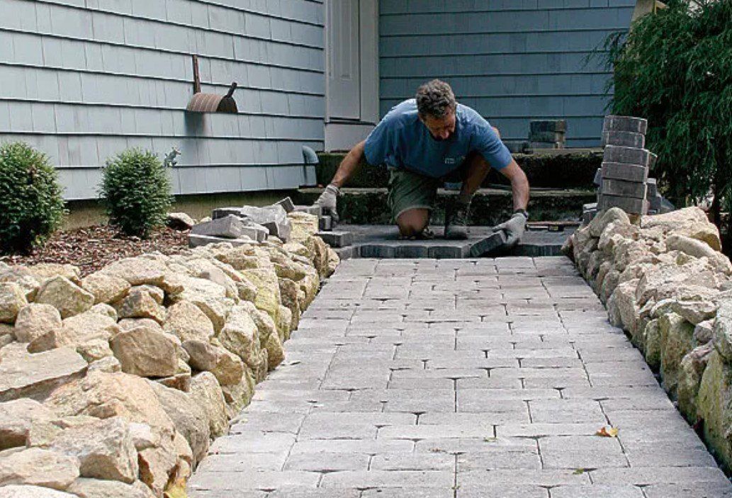 Walkway paving done by riverside retaining wall