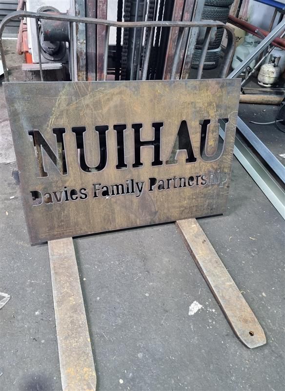 A sign that says nuihaus is sitting on a wooden forklift.